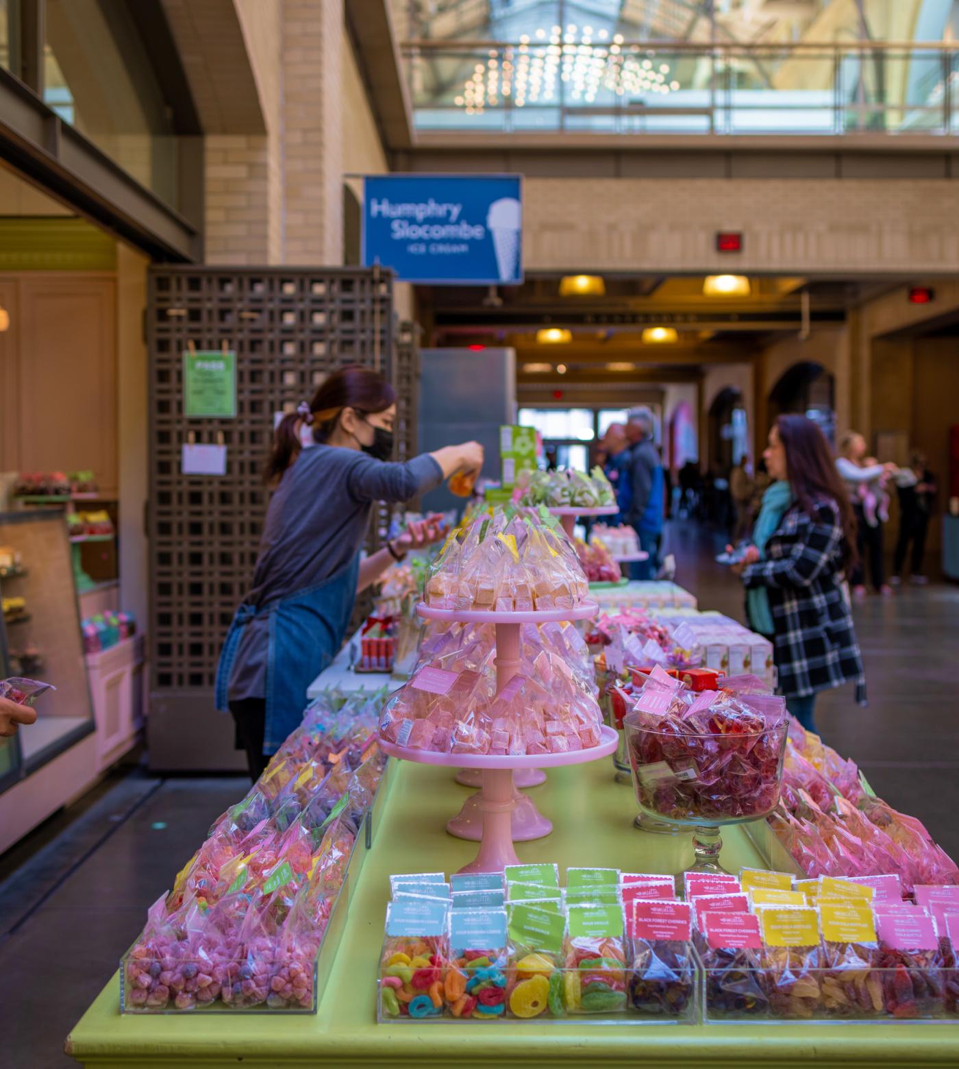 View of a vendor arranging products inside the Ferry Building.
